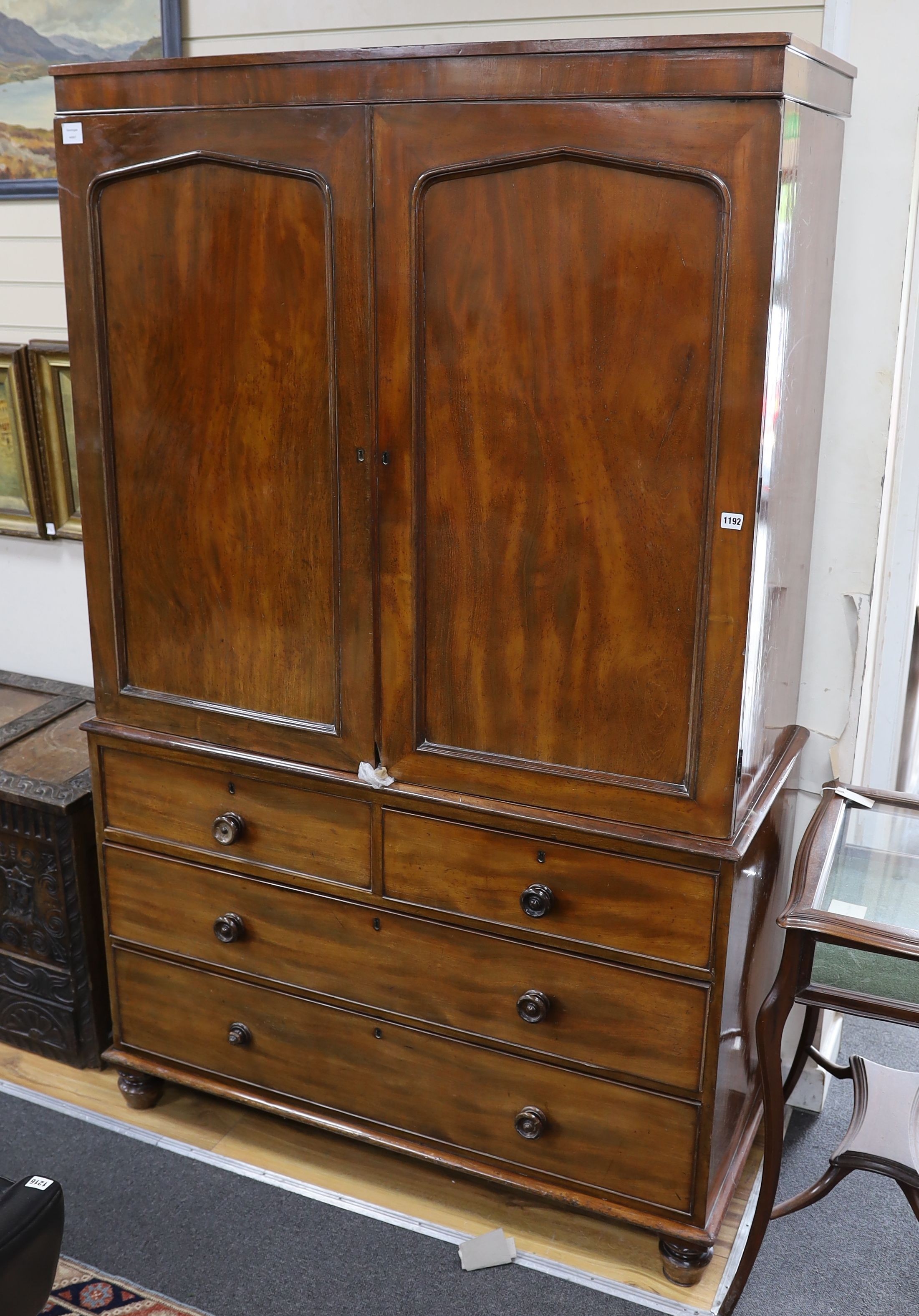 A Regency mahogany linen press, the top retaining sliding trays, length 124cm, depth 56cm, height 200cm